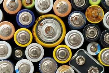 Close up top view of used battery. lot of AA batteries. Electronic hazardous waste, recycling concept