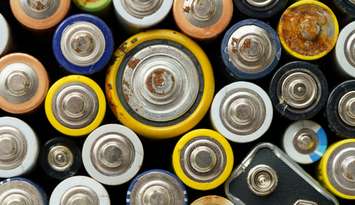 Close up top view of used battery. lot of AA batteries. Electronic hazardous waste, recycling concept