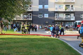 Evacuated residents wait outside their apartment building on Rivard Ave. in Windsor after a fire, October 7, 2015.  (Photo by Adelle Loiselle)