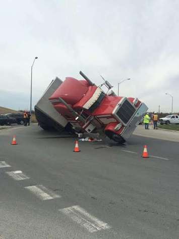 A tractor trailer flips over at the roundabout at Hwy. 3 and Hwy. 401, April 14, 2015. (Photo courtesy of Steve Dilauto)