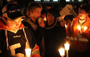 Teammates, friends and family of Michael Matte gather outside of General Amherst High School for a candlelight vigil, November 10, 2014. (photo by Mike Vlasveld)