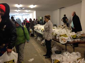 Residents line up for for the Mikhail Holdings turkey giveaway in a building on Ouellette Avenue in downtown Windsor, December 18, 2015. (Photo by Maureen Revait)