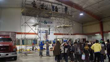 Workers demonstrate the appropriate safety harnesses. (Photo by Jake Jeffrey)