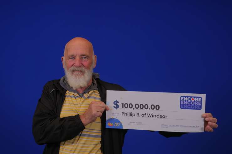 Phil Bistany of Windsor with his $100,000 prize cheque at the OLG Prize Centre in Toronto. Photo courtesy Ontario Lottery and Gaming.