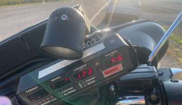 A radar device showing a reading of 122 kilometres per hour is seen on an OPP motorcycle on Highway 3 in Kingsville, September 16, 2025. Photo courtesy OPP West Region/X.