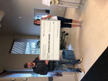 Andy Clifford of the East St. Clair Wind Farm with Brenda LeClair of Chatham Outreach For Hunger. May 2020. (Photo courtesy of Jason Stoner). 