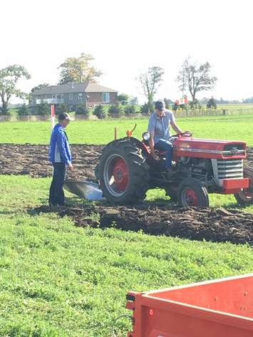 Prime Minister Justin Trudea plows at the 2017 IPM with some help from Brian McGavin. (Photo by Blackburn Radio staff)