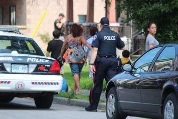 Windsor police swarm the 900 block of Chatham St. E after reports of a break and enter. (Photo by Jason Viau)