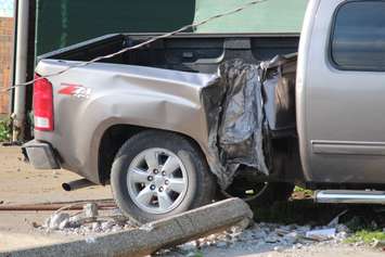 A truck knocks down two hydro poles and smashes through a fence on Drouillard just north of Franklin St., June 10, 2015. (Photo by Jason Viau)