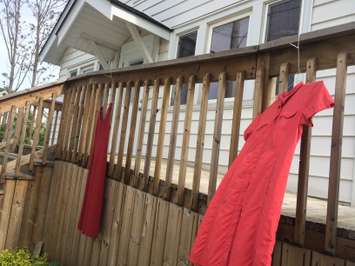 Red dresses hang outside the Caldwell First Nation office in Leamington on May 20, 2015. (Photo by Ricardo Veneza)