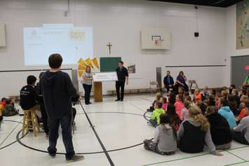 Best Buy reps presenting a grant to the St. Elizabeth Catholic School at a school assembly. November 2, 2016. (Photo by Natalia Vega)