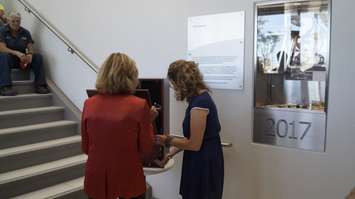 Lambton College President Judy Morris and English teacher Erica Kelly close a time capsule that will be opened in 2067.  August 29, 2019 Photo by Melanie Irwin