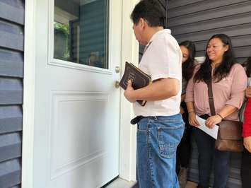 Douglas Lopez turns the key to his family's new Habitat For Humanity home - May 30/22 (Blackburn Media photo by Josh Boyce)
