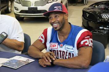 Daryl Townsend of the Montreal Alouettes signs autographs at Performance Ford in Windsor, April 9, 2015. (Photo by Mike Vlasveld)