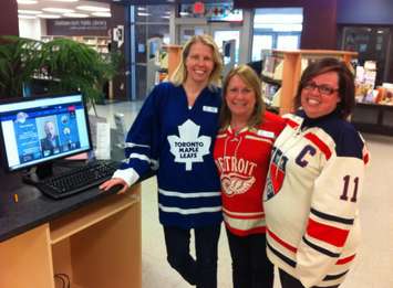 Chatham-Kent Public Library staff are wearing hockey jerseys to remind people to vote in the Kraft Hockeyville challenge. (Photo by Mike James)