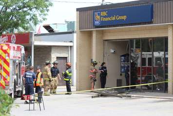 Three people were sent to hospital after a car smashes through the front of an RBC Bank on Huron Church Rd., July 3, 2015. (Photo by Jason Viau)