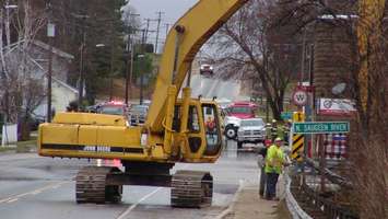 Workers try to clear debris from the dam in Williamsford. (Photo by Kirk Scott)