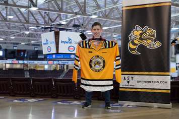 Kaleb Orrange, 10, holding a Sarnia Sting jersey after being named Esso's Extra Mile youth winner. March 2021. (Photo by Metcalfe Photography)