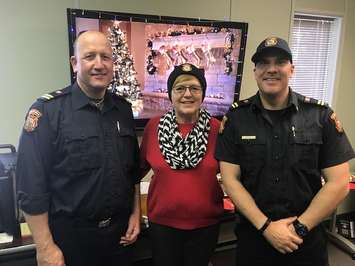 Sarnia firefighters Roel Bus (left) and Mike Otis (right) with Lee Michaels. December 18, 2018. (Photo my Melanie Irwin, BlackburnNews)