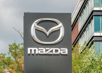Mazda at the entrance of a car dealership (Image by Cristi Croitoru / iStock Editorial / Getty Images Plus)
