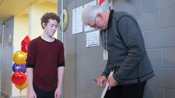 Cole Martin gets Rick Vaive's autographs at the We're All Stars Celebration in London, February 23, 2016. Photo by Miranda Chant.