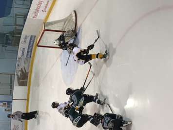 Two Mitchell players nearly score against Twin Centre during their 4-3 win in the Novice 