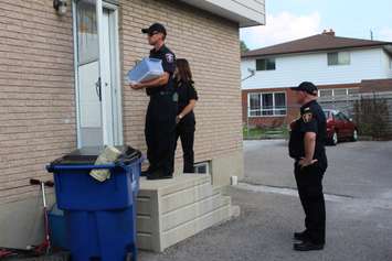 Chatham-Kent firefighters going door-to-door on Timmins Cres., during their post fire reassurance initiative. September 6, 2016. (Photo by Natalia Vega)