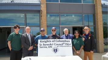 Student Marcus Bastien, Director of Education Scott Johnson, Don Melanson and Leo Mayer from the Knights of Columbus, Father Dan Vere, student Pavi Padmananthan, and Bob Fleming of the Knights of Columbus. May 2022. (Photo courtesy of the St. Clair Catholic District School Board)